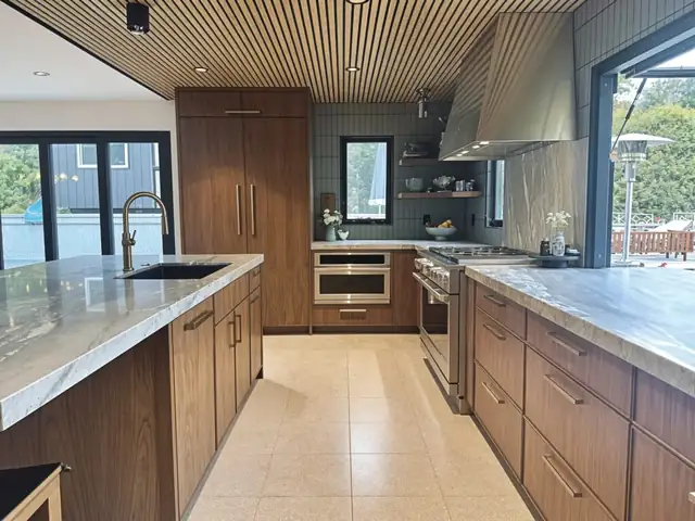 San Juan Capistrano kitchen remodel with walnut custom cabinets, slatted wood ceiling and quartzite counters